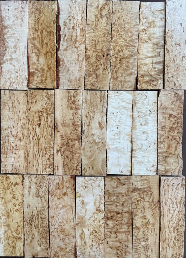 An assortment of karelian masur birch wood scales.